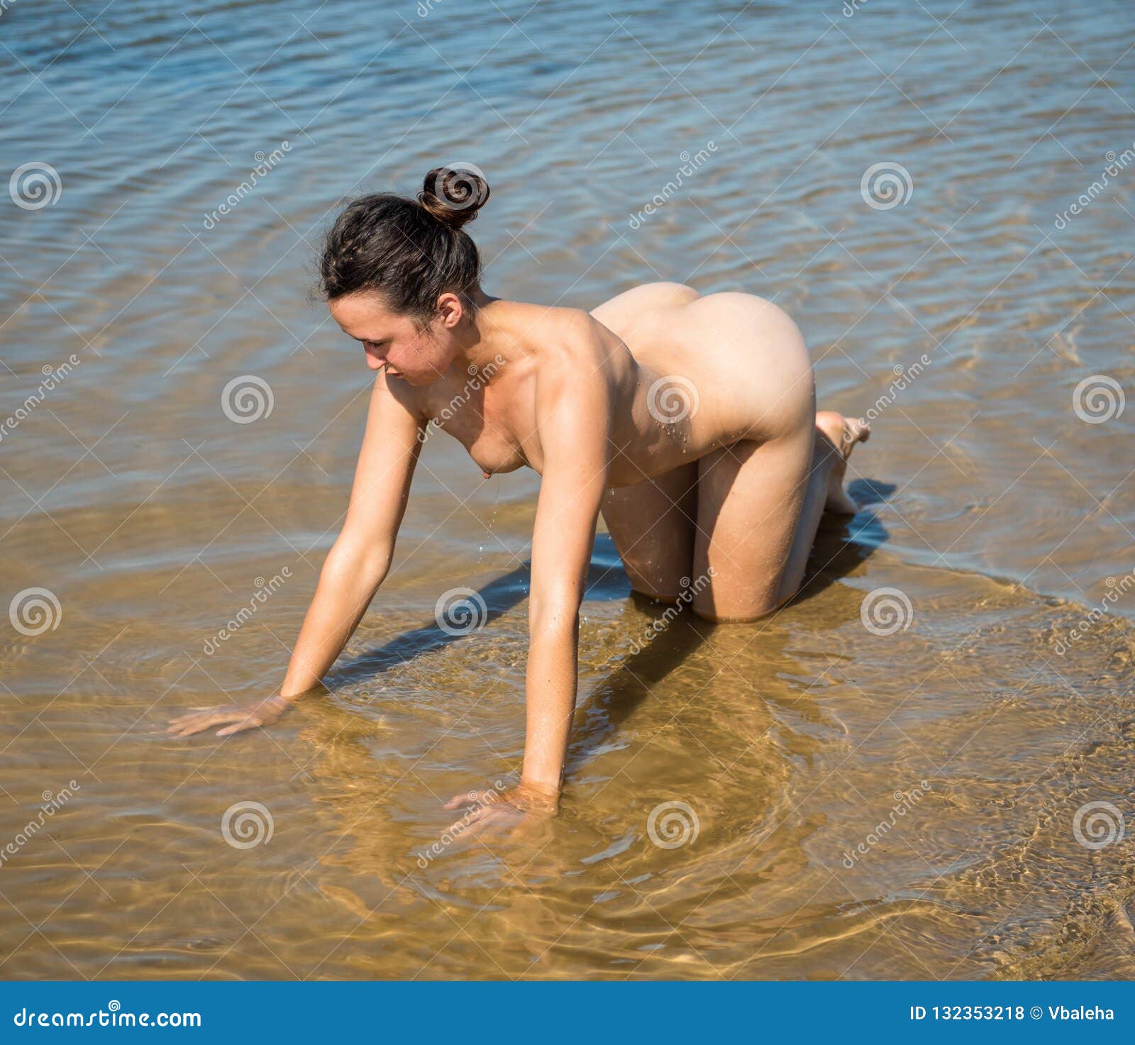 beautiful naked young woman posing sea
