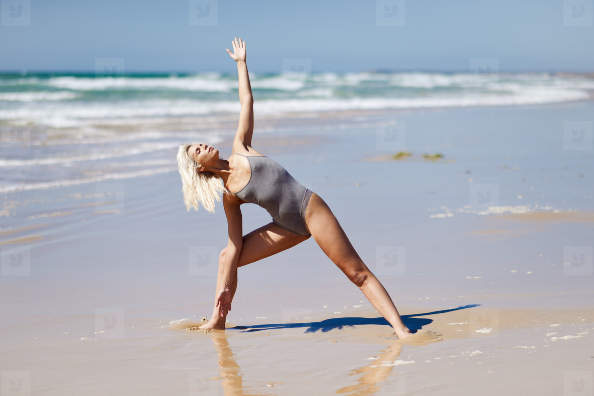 caucasian blonde woman practicing yoga in